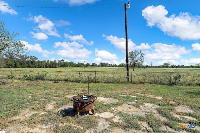 view of yard with a rural view and an outdoor fire pit