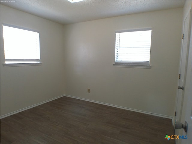 empty room featuring dark hardwood / wood-style flooring