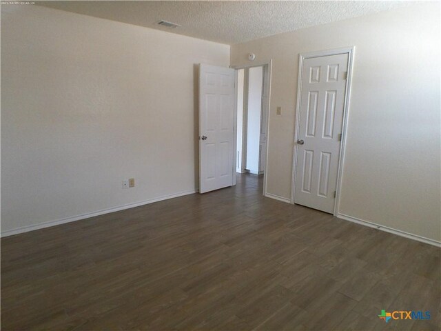 507 Hackberry St, Copperas Cove, TX 76522 - empty room with dark wood-style floors and a textured ceiling