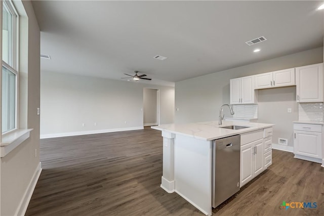 kitchen featuring tasteful backsplash, a sink, dark wood-style floors, white cabinetry, and stainless steel dishwasher