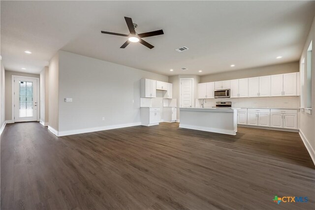 unfurnished living room with visible vents, ceiling fan, baseboards, recessed lighting, and dark wood-style flooring