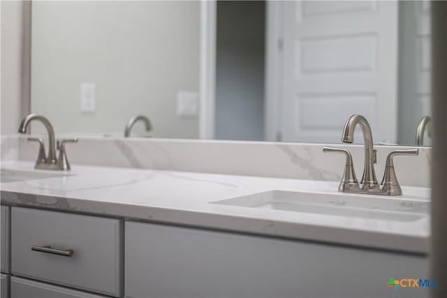 bathroom featuring double vanity and a sink