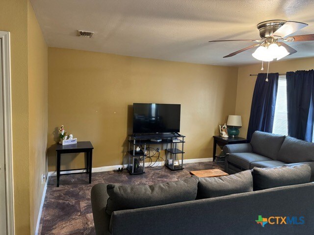 living room featuring ceiling fan