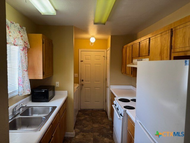 kitchen with white appliances and sink