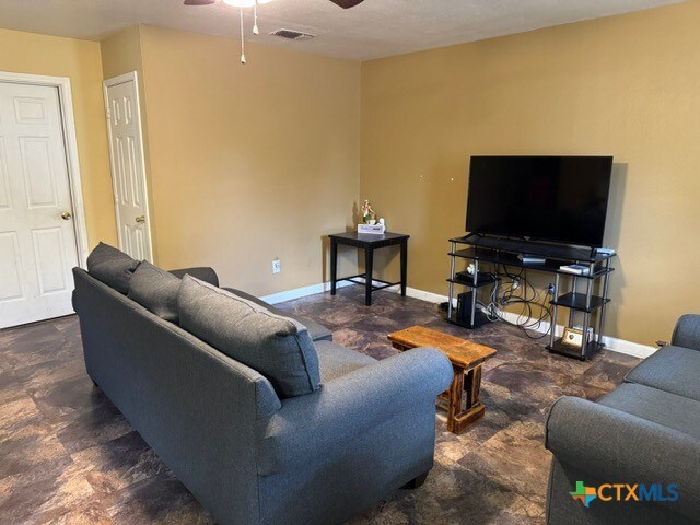 living room featuring ceiling fan