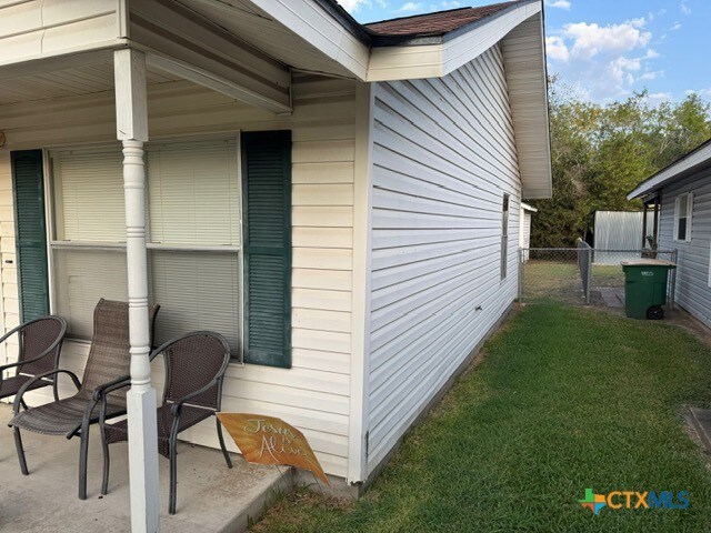 view of side of home featuring a lawn