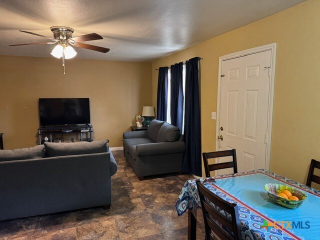 living room featuring ceiling fan