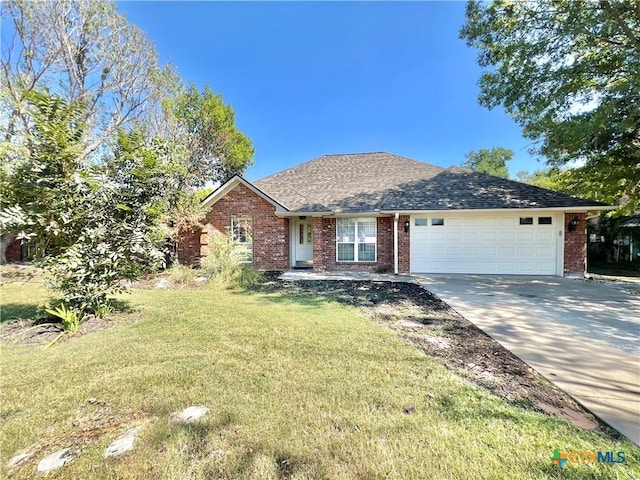 ranch-style house with driveway, a front yard, a garage, and brick siding
