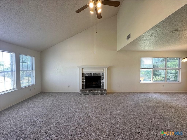2707 Tripp Trl, Killeen, TX 76543 - unfurnished living room with a textured ceiling, plenty of natural light, carpet floors, ceiling fan, and lofted ceiling