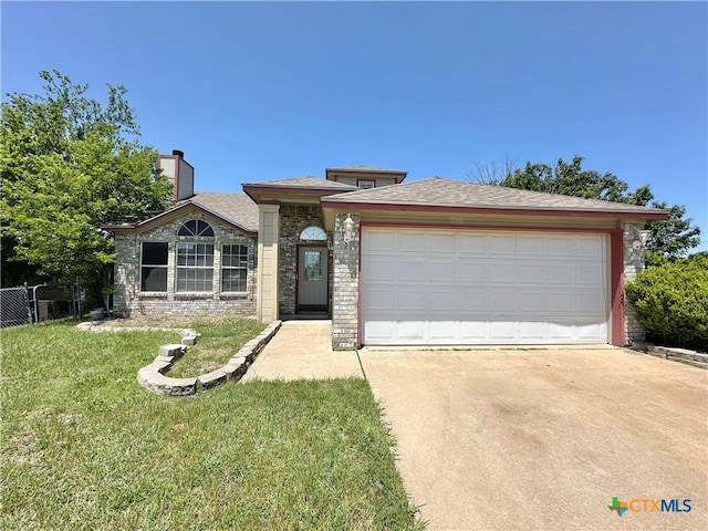 2707 Tripp Trl, Killeen, TX 76543 - view of front facade with concrete driveway, brick siding, an attached garage, and a chimney