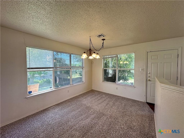 2707 Tripp Trl, Killeen, TX 76543 - unfurnished dining area with a chandelier, a textured ceiling, carpet floors, and baseboards