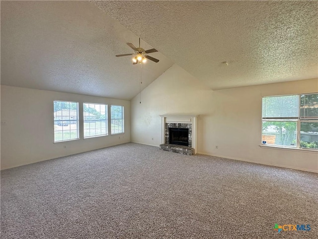 2707 Tripp Trl, Killeen, TX 76543 - unfurnished living room featuring a textured ceiling, healthy amount of natural light, a fireplace, ceiling fan, and carpet floors