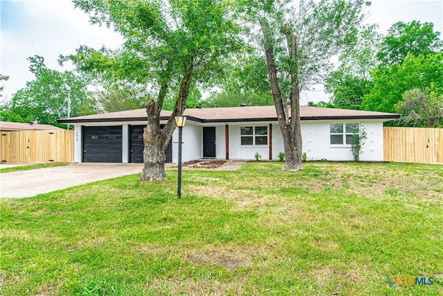 single story home featuring a front lawn and a garage