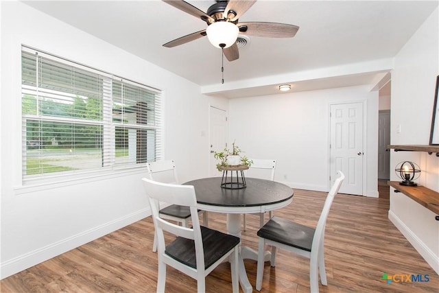 dining area featuring ceiling fan and hardwood / wood-style floors