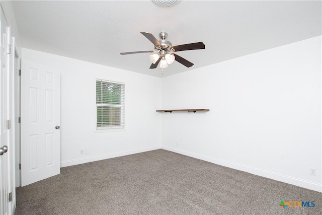 carpeted spare room featuring ceiling fan