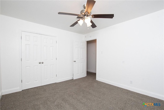 unfurnished bedroom with ceiling fan, a closet, and dark carpet