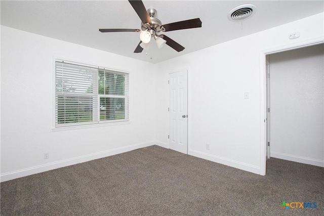 unfurnished bedroom featuring ceiling fan and dark colored carpet