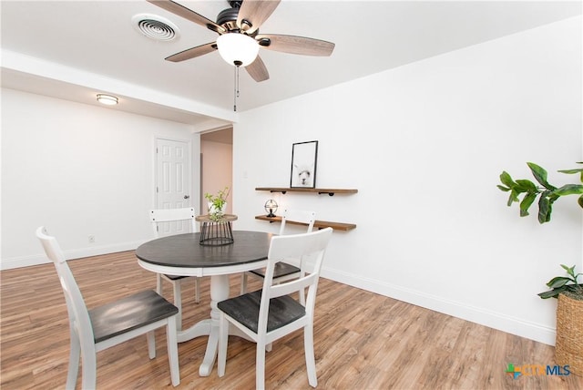 dining space featuring ceiling fan and light hardwood / wood-style floors