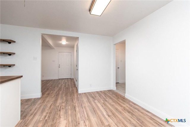 unfurnished room with light wood-type flooring