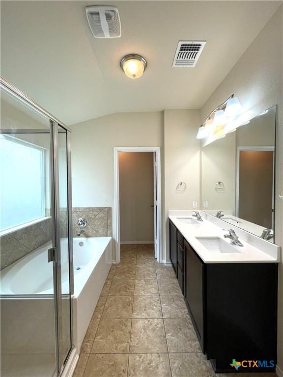 bathroom with plus walk in shower, vanity, and tile patterned flooring