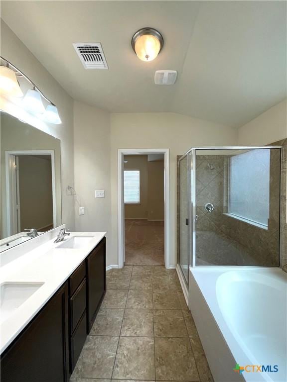 bathroom featuring tile patterned floors, vanity, independent shower and bath, and vaulted ceiling