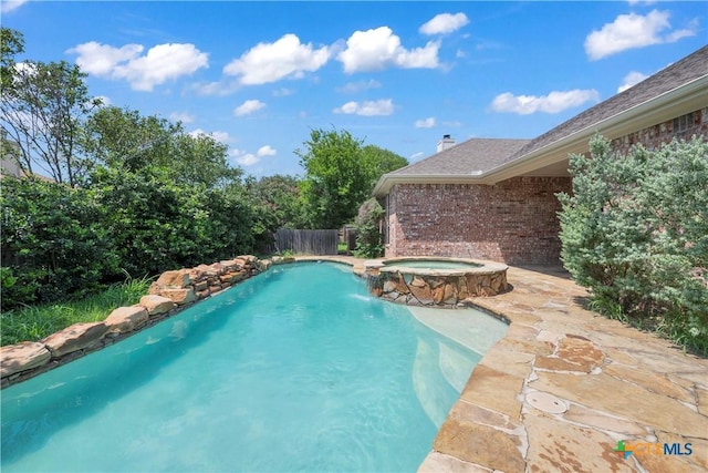 view of swimming pool featuring an in ground hot tub