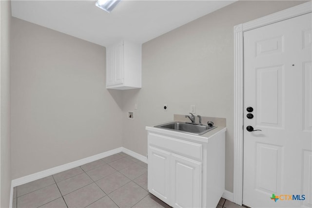 washroom featuring cabinets, light tile patterned floors, hookup for a washing machine, and sink