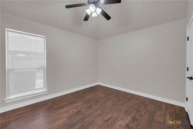 empty room featuring ceiling fan and dark wood-type flooring