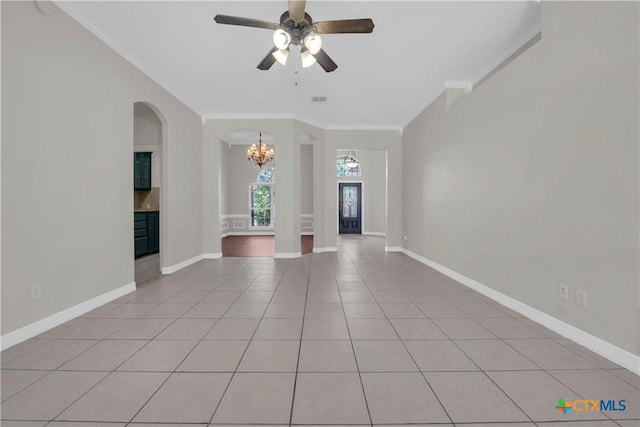 unfurnished living room featuring ceiling fan with notable chandelier, ornamental molding, and light tile patterned floors