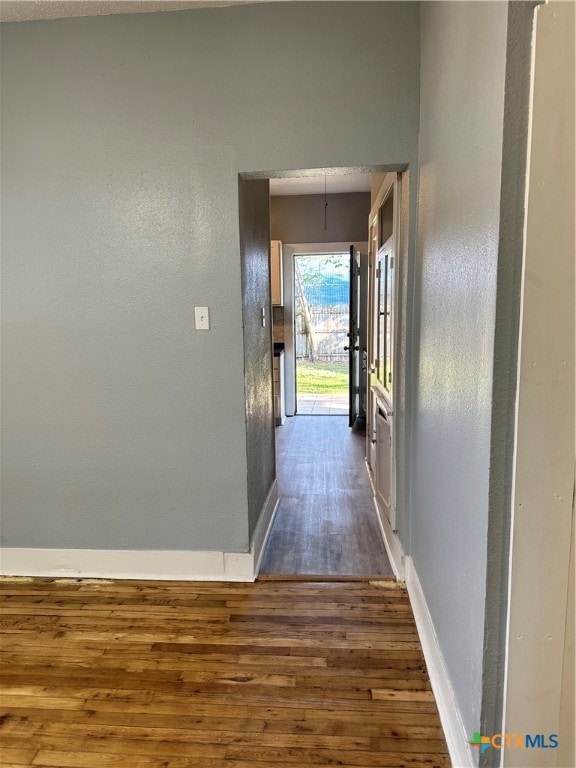 corridor with dark hardwood / wood-style floors