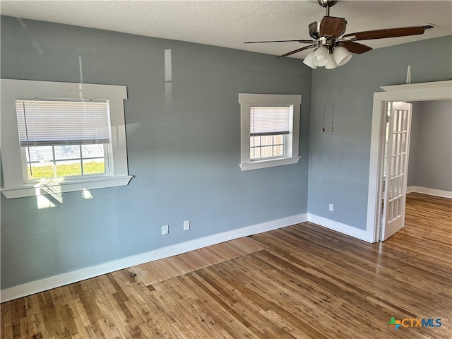 spare room with hardwood / wood-style floors, a textured ceiling, and ceiling fan