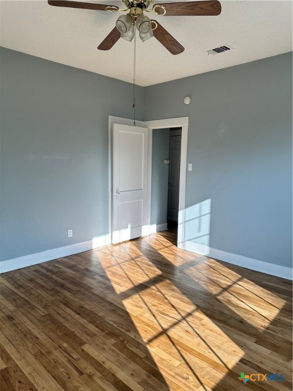 spare room featuring hardwood / wood-style floors, a textured ceiling, and ceiling fan