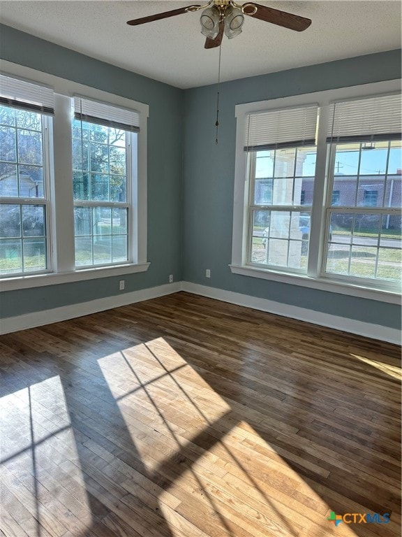 spare room with ceiling fan, dark hardwood / wood-style flooring, and a textured ceiling