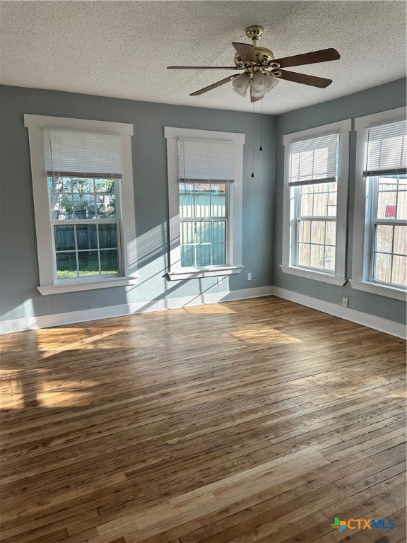 unfurnished room featuring hardwood / wood-style floors, a textured ceiling, and ceiling fan