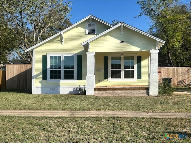 bungalow-style house featuring a porch and a front lawn