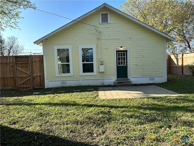 rear view of house featuring a patio and a lawn