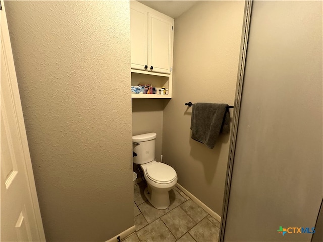 bathroom with tile patterned floors and toilet