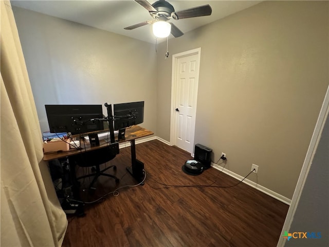 home office with dark wood-type flooring and ceiling fan