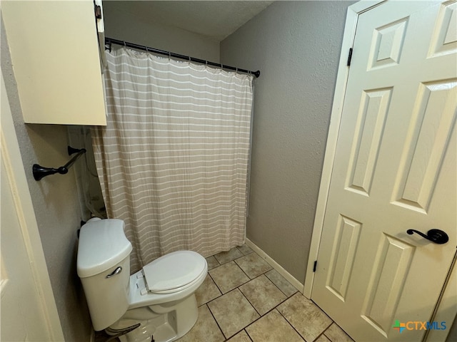 bathroom featuring tile patterned floors and toilet