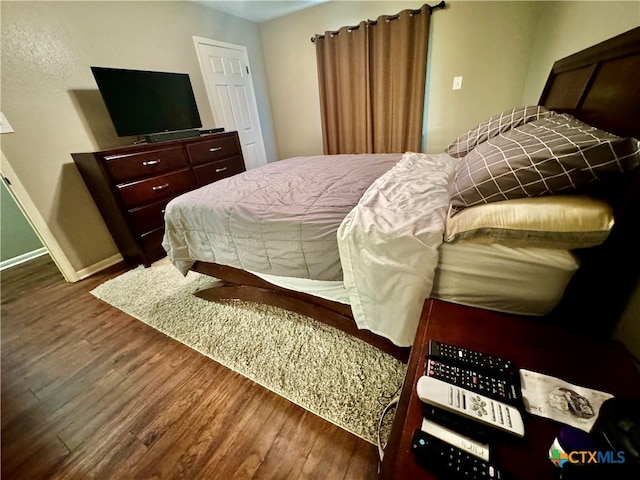 bedroom featuring dark wood-type flooring