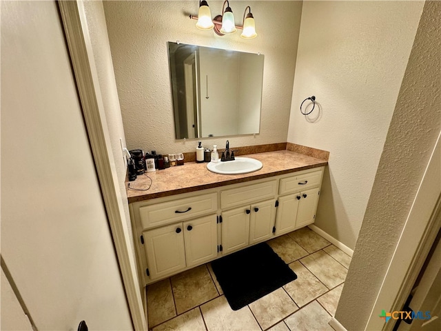 bathroom featuring tile patterned flooring and vanity