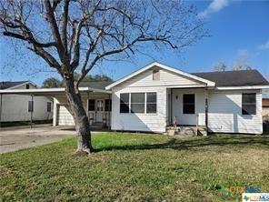 view of front of home with a garage and a front yard