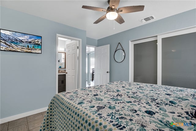 tiled bedroom with ceiling fan, connected bathroom, and a closet