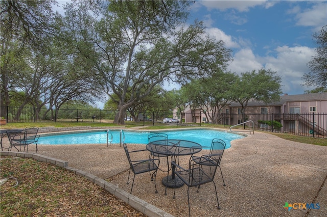 view of swimming pool with a patio