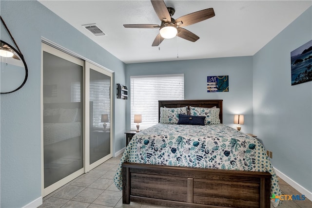 tiled bedroom featuring ceiling fan