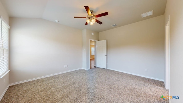 unfurnished room with vaulted ceiling, carpet flooring, and ceiling fan