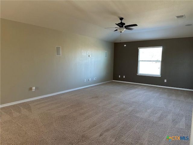 empty room with ceiling fan and carpet floors