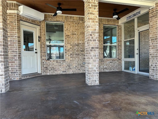 view of exterior entry featuring a wall mounted air conditioner, ceiling fan, and a patio