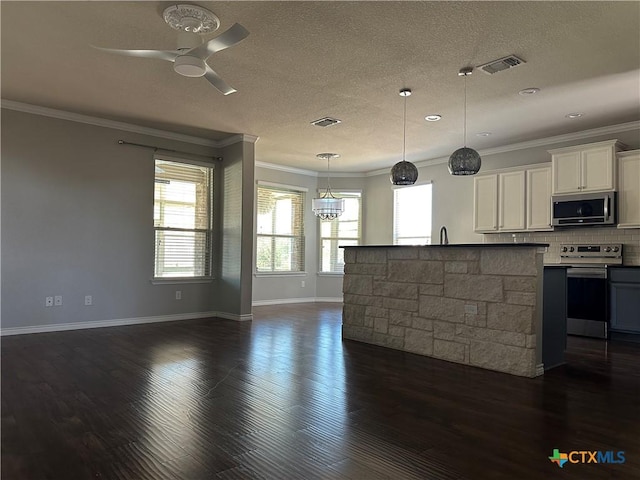 kitchen featuring a wealth of natural light, white cabinetry, hanging light fixtures, and stainless steel appliances