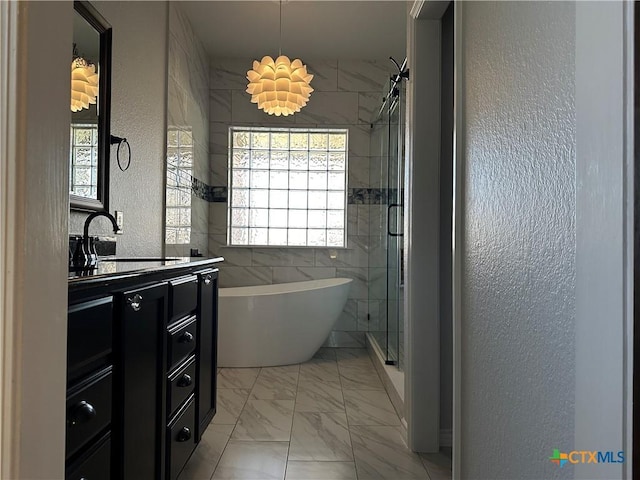 bathroom featuring plus walk in shower and vanity